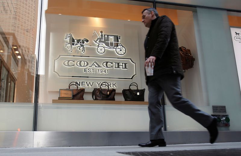 © Reuters. FILE PHOTO: A man walks past a Coach store on Madison Avenue in New York, January 23, 2013. REUTERS/Carlo Allegri