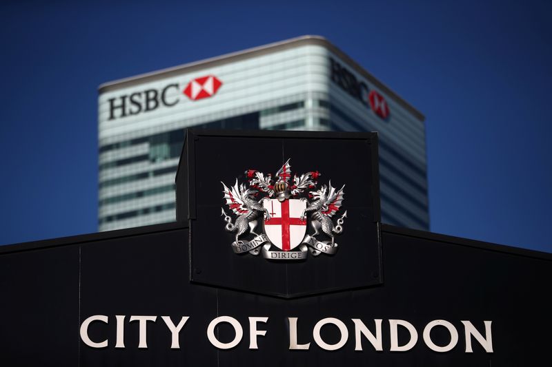 &copy; Reuters. FILE PHOTO: HSBC's building in Canary Wharf is seen behind a City of London sign outside Billingsgate Market in London, Britain, August 8, 2018. REUTERS/Hannah McKay