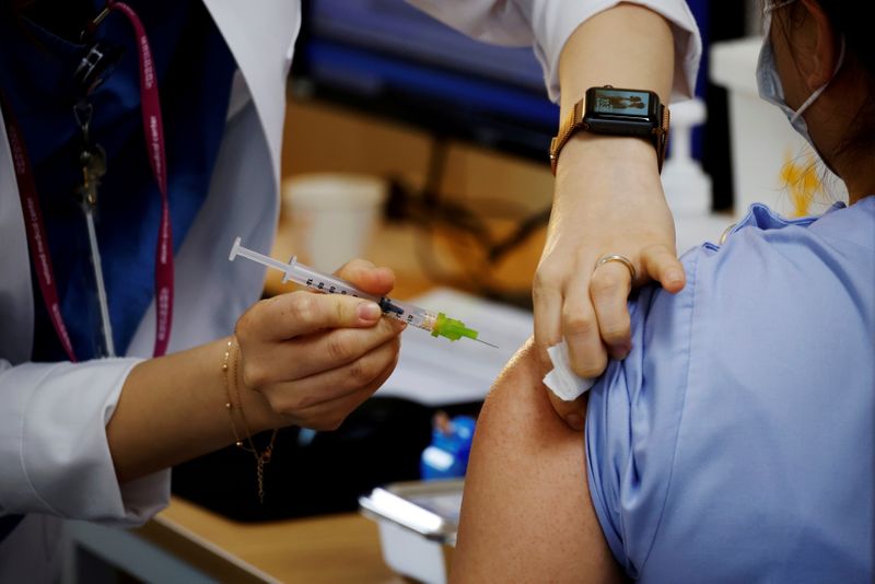 &copy; Reuters. FOTO DE ARCHIVO: Un trabajador sanitario recibe una dosis de la vacuna contra el coronavirus de Pfizer-BioNTech en un centro de vacunación en Seúl, Corea del Sur, el 10 de marzo de 2021. REUTERS/Kim Hong-Ji