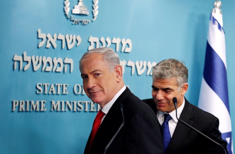 &copy; Reuters. FILE PHOTO: Israeli Prime Minister Benjamin Netanyahu (L) and Finance Minister Yair Lapid leave after a joint news conference in Jerusalem July 3, 2013. REUTERS/Ronen Zvulun/File Photo