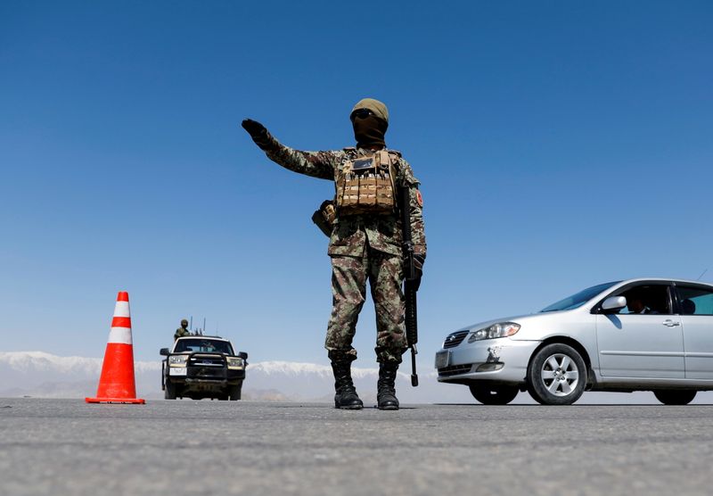 &copy; Reuters. FILE PHOTO: An Afghan National Army soldier stands guard at a checkpoint on the outskirts of Kabul