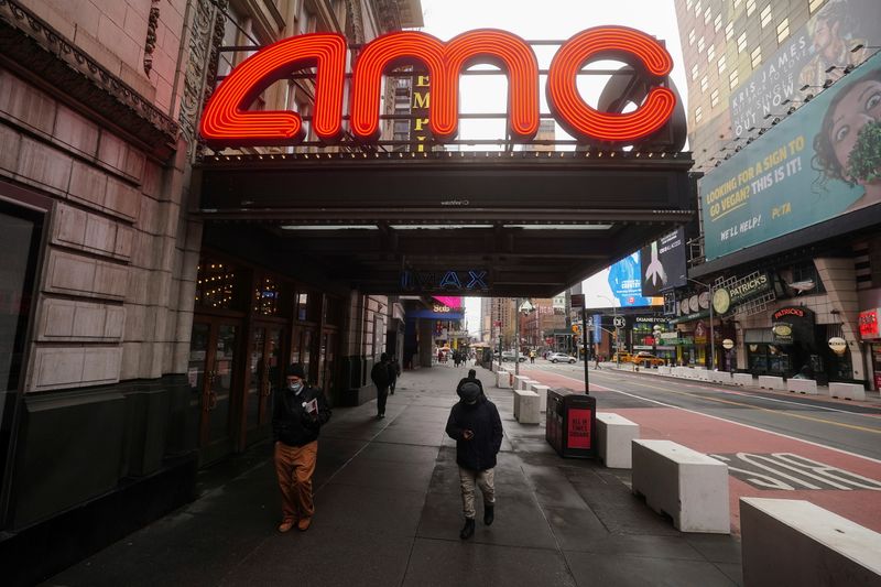 &copy; Reuters. FIEL PHOTO: People walk past an AMC theatre amid the coronavirus disease (COVID-19) pandemic in the Manhattan borough of New York City, New York, U.S., January 27, 2021. REUTERS/Carlo Allegri