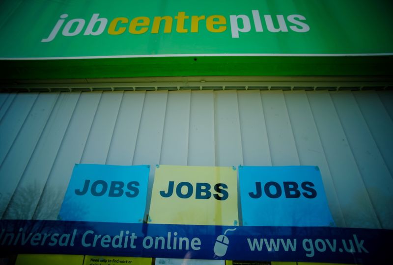 © Reuters. FILE PHOTO: Adverts for jobs are seen in the window of a Jobcentre Plus in Manchester, Britain, March 2, 2021. REUTERS/Phil Noble