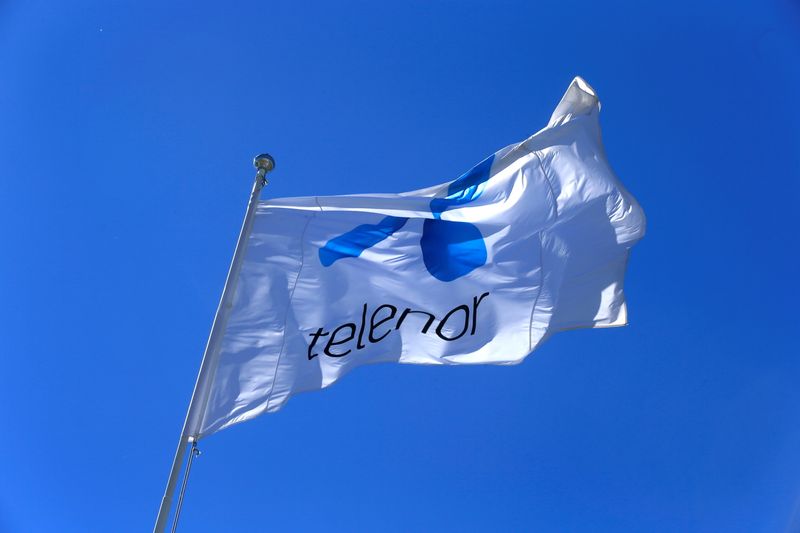 &copy; Reuters. FILE PHOTO: Telenor flag flutters next to the company&apos;s headquarters in Fornebu