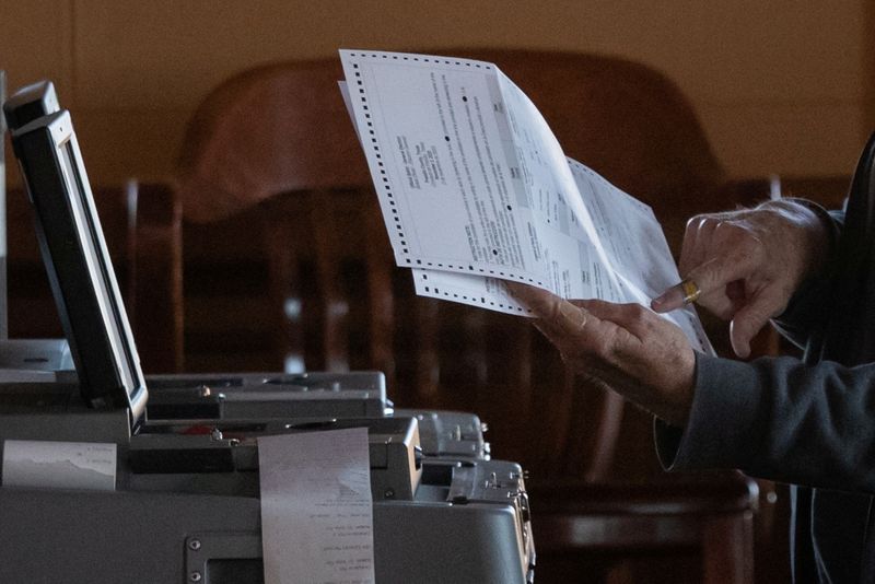 &copy; Reuters. FILE PHOTO: An election official points towards a mail in ballot while scanning votes for the 2020 U.S. presidential election in Marfa, Texas, U.S., November 3, 2020. REUTERS/Adrees Latif