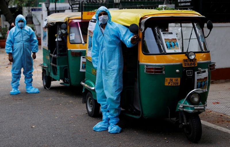 &copy; Reuters. FILE PHOTO: Drivers stand near auto rickshaw ambulances, prepared to transfer people suffering from the coronavirus disease (COVID-19) and their relatives for free, in New Delhi, India May 5, 2021.   REUTERS/Adnan Abidi