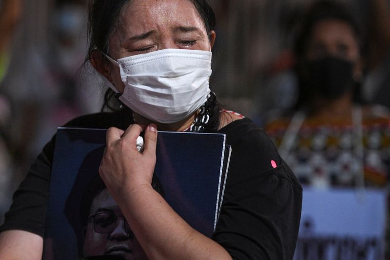 &copy; Reuters. FILE PHOTO: Sureerat Chiwarak, mother of arrested anti-government protest leader Parit "Penguin" Chiwarak, who faces lese majeste charges, attends a demonstration demanding his release after his hospitalization following a 46-day hunger strike, in Bangkok