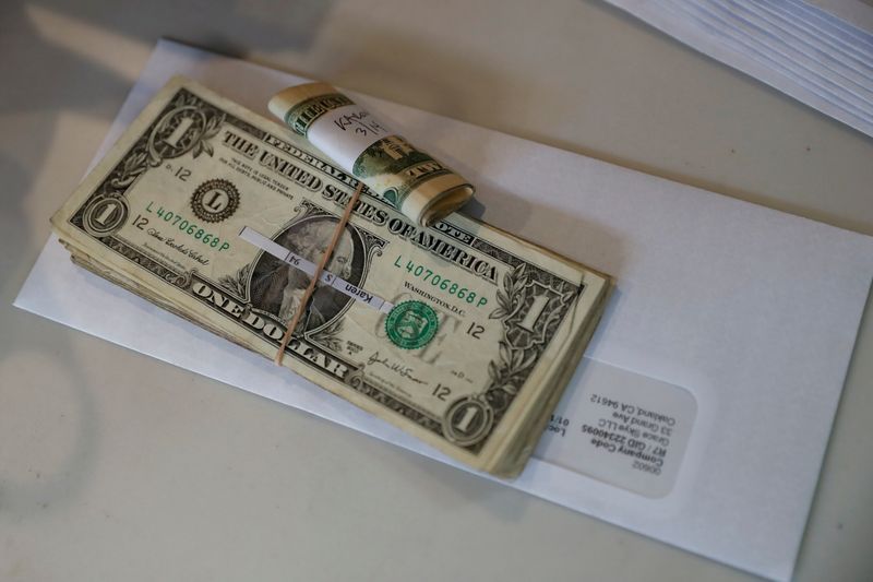 &copy; Reuters. FILE PHOTO: Tips, money collected from a customer donation fund and a last paycheck for employees laid off from Farley’s East cafe, that closed due to the financial crisis caused by the coronavirus disease (COVID-19), sits on a counter at the cafe in Oa