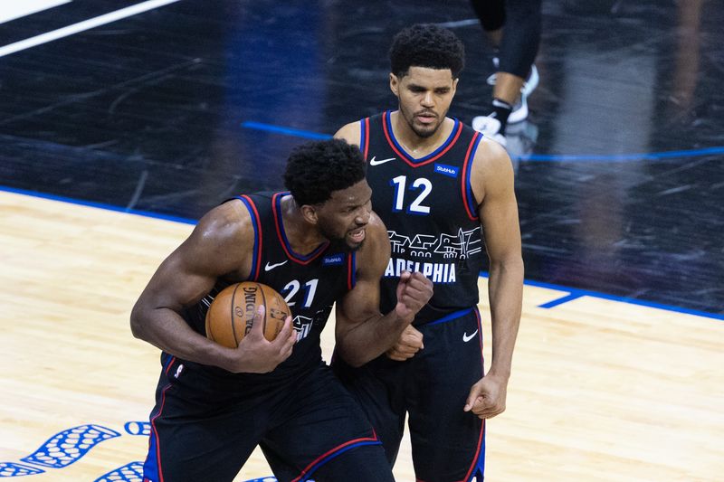 &copy; Reuters. May 7, 2021; Philadelphia, Pennsylvania, USA; Philadelphia 76ers center Joel Embiid (21) and forward Tobias Harris (12) react after forcing a jump ball in the closing seconds of the fourth quarter against the New Orleans Pelicans at Wells Fargo Center. Ma