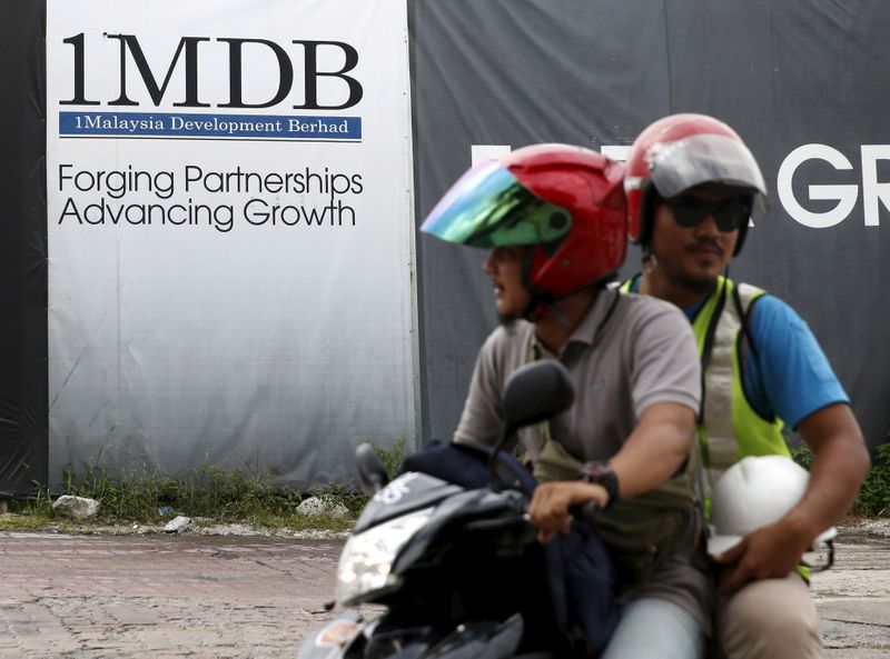 &copy; Reuters. FILE PHOTO: Motorcyclists pass a 1Malaysia Development Berhad (1MDB) billboard at the Tun Razak Exchange development in Kuala Lumpur, Malaysia, February 3, 2016. REUTERS/Olivia Harris