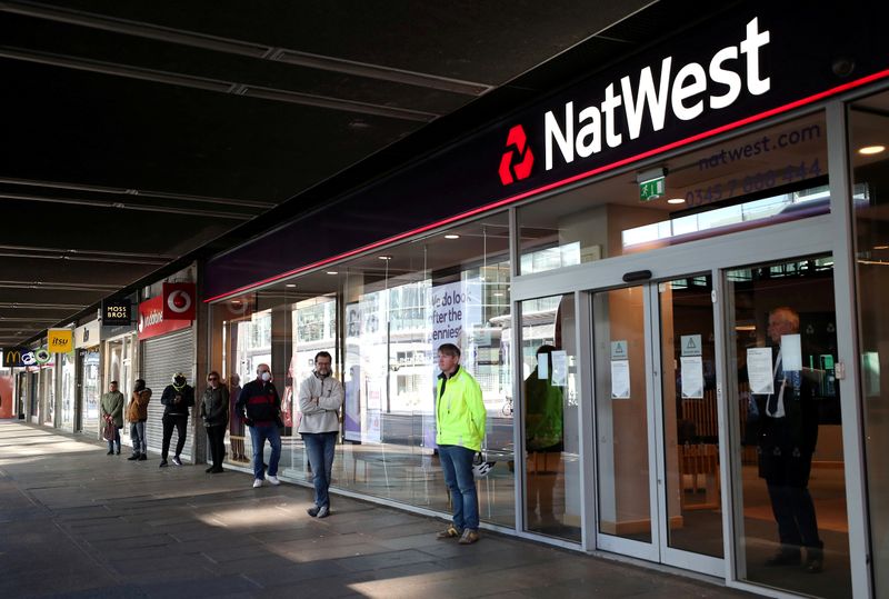 &copy; Reuters. FILE PHOTO: People maintain social distance while they queue outside a Natwest bank as the spread of the coronavirus disease (COVID-19) continues, in London, Britain, March 26, 2020. REUTERS/Hannah McKay/File Photo