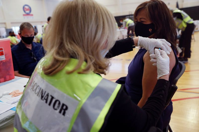 &copy; Reuters. FILE PHOTO: Volunteer nurse practitioner Ellyn Troisi applies the second dose of the Moderna COVID-19 Vaccine to Sopee Harnett at the Town of North Hempstead's "Yes We Can" Community Center, in Westbury, New York, U.S., May 6, 2021. REUTERS/Shannon Staple