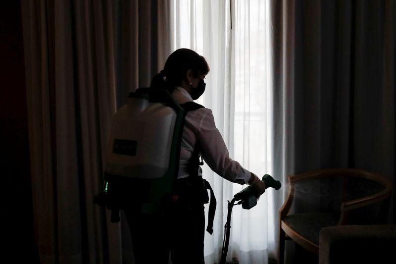 &copy; Reuters. A woman sprays desinfectant in a hotel room amid the coronavirus disease (COVID-19) pandemic in Lisbon, Portugal, May 11, 2021. REUTERS/Pedro Nunes