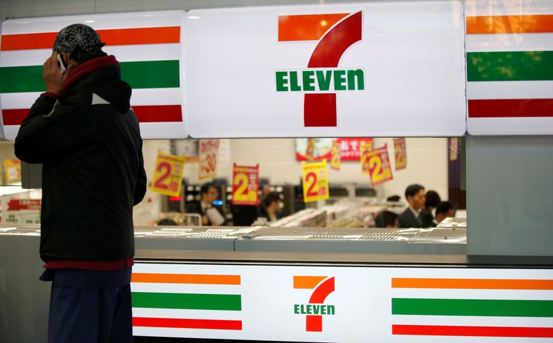 &copy; Reuters. A man uses a mobile phone outside a 7-Eleven convenience store in Tokyo