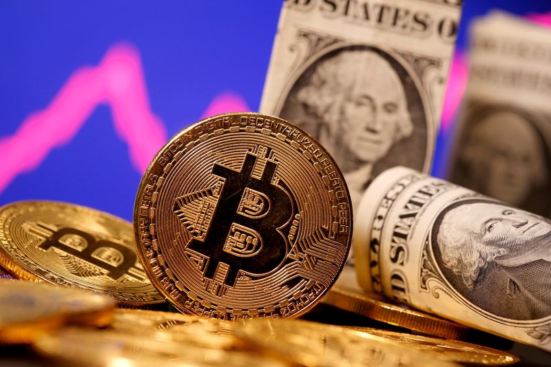 &copy; Reuters. FILE PHOTO: A representation of virtual currency Bitcoin and U.S. One Dollar banknotes are seen in front of a stock graph in this illustration taken January 8, 2021. REUTERS/Dado Ruvic/File Photo