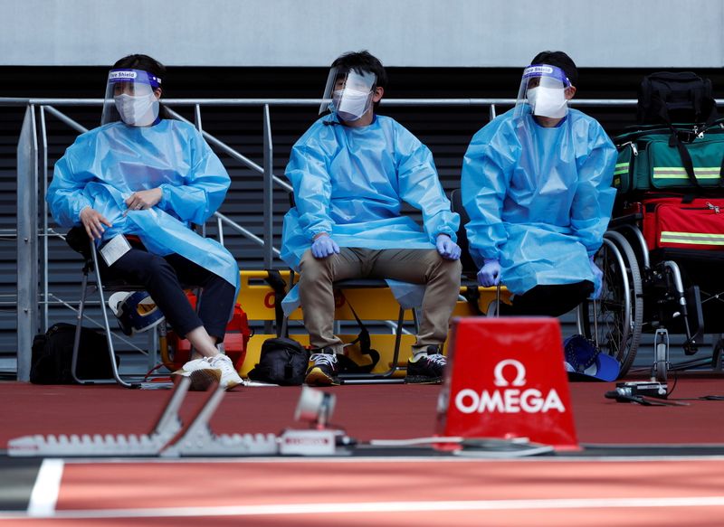 &copy; Reuters. FILE PHOTO: Olympics - Tokyo 2020 Olympic Games Test Event - Athletics - Olympic Stadium, Tokyo, Japan - May 9, 2021. Medical officers wearing protective suits are seen at the morning session of the Athletics test event. REUTERS/Issei Kato/File Photo