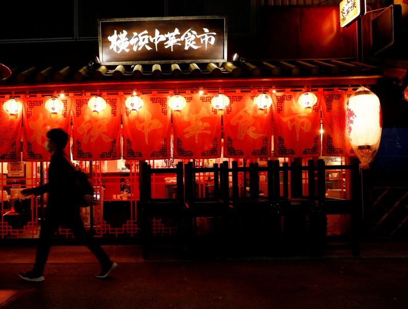 &copy; Reuters. FILE PHOTO: A man wearing a protective face mask walks past a restaurant which is closed after 8 PM, on the first day of the country's third state of emergency, amid  the coronavirus disease (COVID-19) outbreak, in Tokyo, Japan, April 25, 2021. REUTERS/Ki