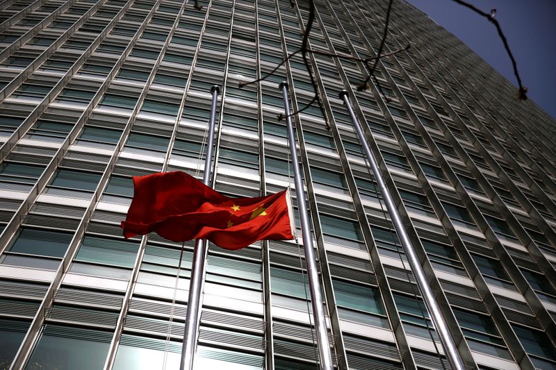 &copy; Reuters. The Chinese national flag flies at half-mast outside a bank in Beijing, as China holds a national mourning for those who died of the coronavirus disease (COVID-19), on the Qingming tomb-sweeping festival, April 4, 2020.  REUTERS/Tingshu Wang