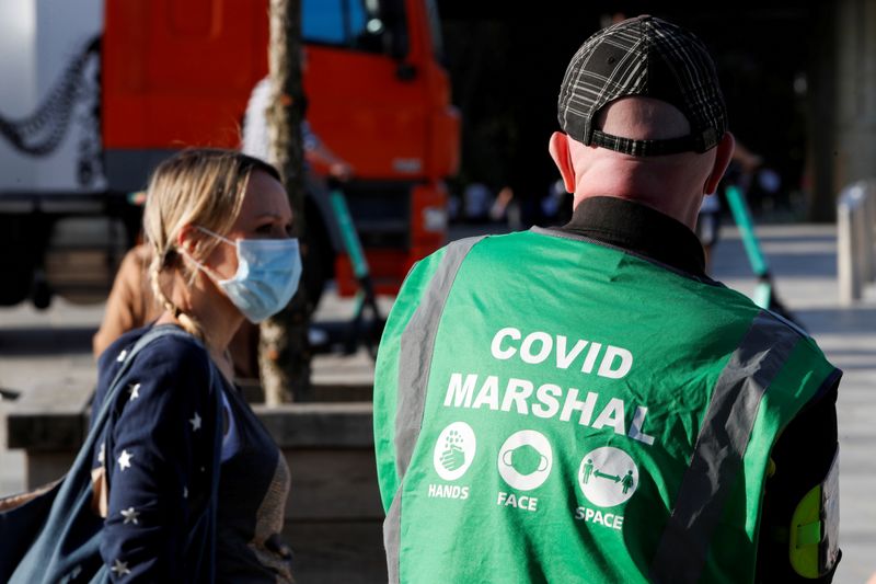 &copy; Reuters. FILE PHOTO: A COVID marshal patrols, amidst the spread of the coronavirus disease (COVID-19), in Bournemouth, Britain, March 30, 2021. REUTERS/Paul Childs/File Photo