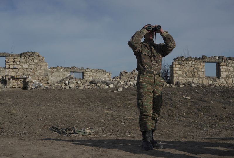 &copy; Reuters. FILE PHOTO: An ethnic Armenian soldier looks through binoculars as he stands at fighting positions near the village of Taghavard in the region of Nagorno-Karabakh, January 11, 2021. Picture taken January 11, 2021. REUTERS/Artem Mikryukov