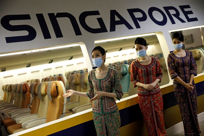 &copy; Reuters. FILE PHOTO: Cabin crew speak to participants during a guided tour at the Singapore Airlines Training Centre in Singapore