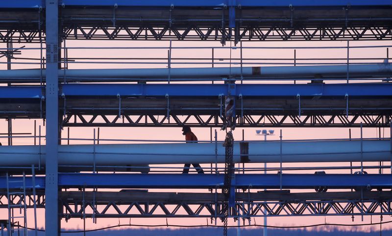 &copy; Reuters. Construction worker walks along a bridge with pipelines at the construction site of Amur gas processing plant, part of Gazprom's Power Of Siberia project outside the far eastern town of Svobodny, in Amur region, Russia November 29, 2019. Picture taken Nov