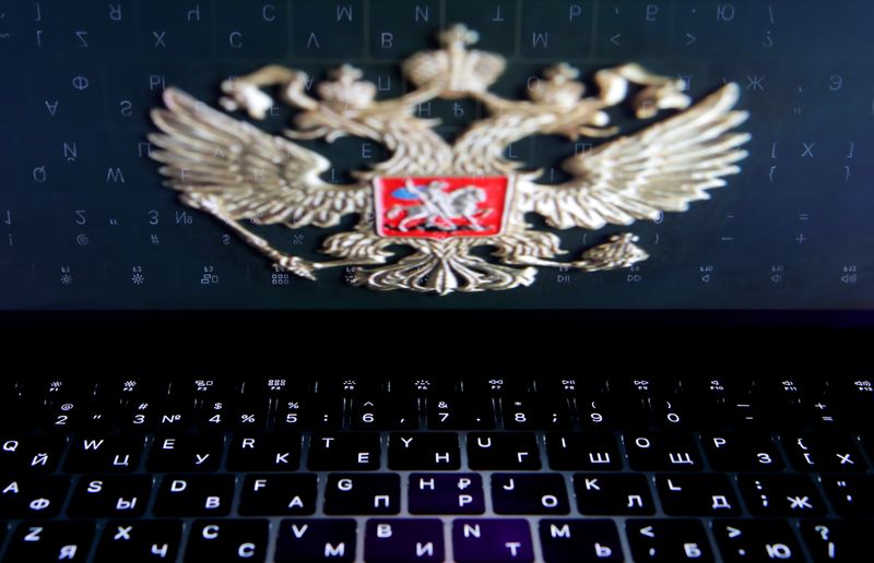 &copy; Reuters. The coat of arms of Russia is reflected in a laptop screen in this picture illustration taken February 12, 2019. REUTERS/Maxim Shemetov