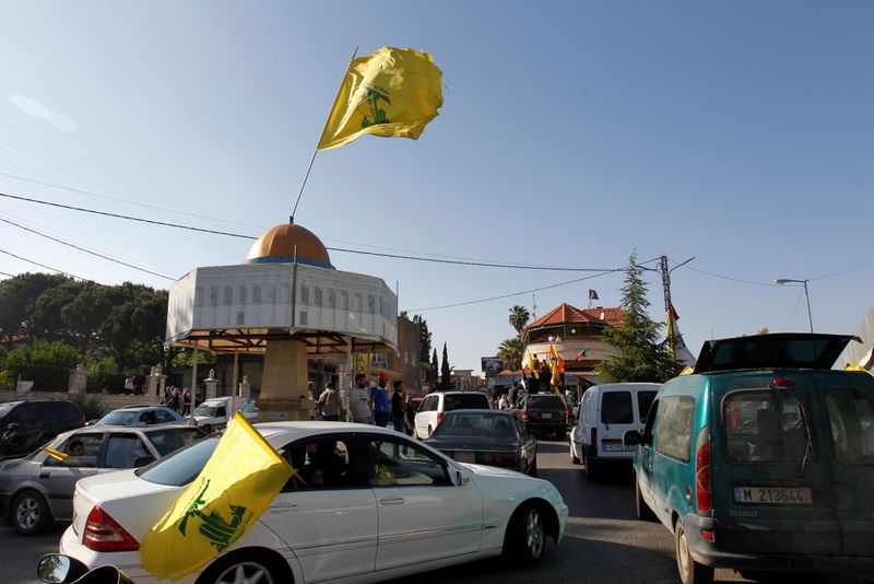 &copy; Reuters. Hezbollah flag flies over a replica of Jerusalem's Dome of the Rock during a protest to express solidarity with the Palestinian people, in Kfar Kila near the border with Israel, southern Lebanon, May 14, 2021. REUTERS/Aziz Taher