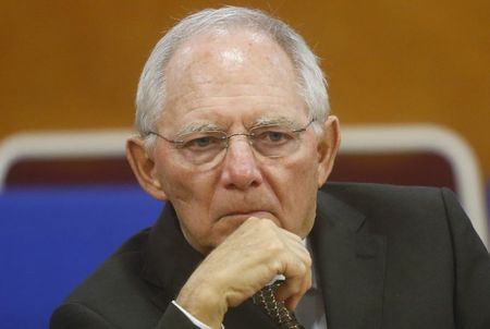 © Reuters. German Finance Minister Wolfgang Schaeuble listens during a talk with his Vietnamese counterpart Dinh Tien Dung at the Finance Ministry in Hanoi