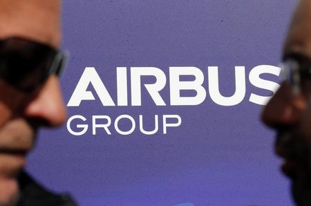 © Reuters. Visitors walk past the logo of Airbus Group during the e-Aircraft Day at the Bordeaux Merignac airport