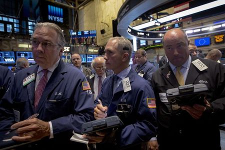 © Reuters. Traders gather at the post where Alibaba Group Holding Ltd is traded on the floor of the New York Stock Exchange