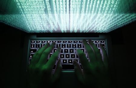 © Reuters. Illustration file picture shows a man typing on a computer keyboard in Warsaw