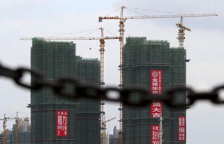 © Reuters. Residential buildings under construction are seen behind a chain in Huai'an