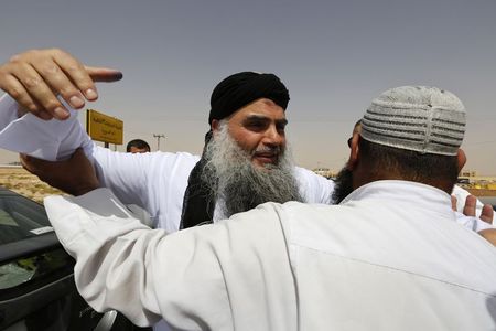 © Reuters. Radical Muslim cleric Abu Qatada hugs his family members after his release from a prison near Amman