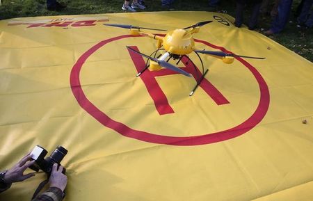 © Reuters. A photojournalist takes picture of a prototype of a DHL "parcelcopter" in Bonn