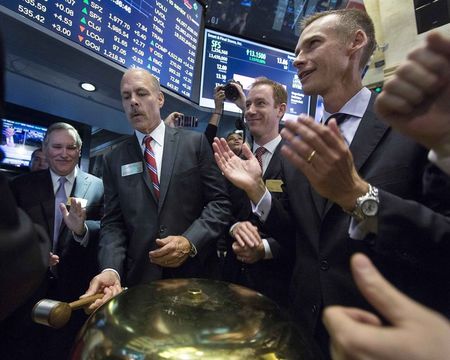 © Reuters. Smart and Final Stores CEO David Hirz celebrates the company's initial listing at The New York Stock Exchange in New York