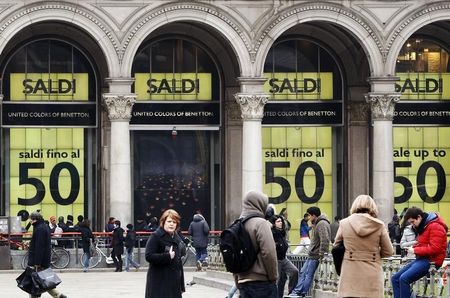 © Reuters. People walk in front of a department store having a sale in downtown Milan