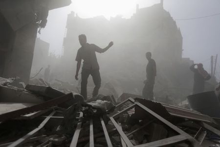 © Reuters. Residents inspect a damaged site after what activists say were four air strikes by forces loyal to Syria's President Bashar al-Assad in Douma, eastern al-Ghouta, near Damascus