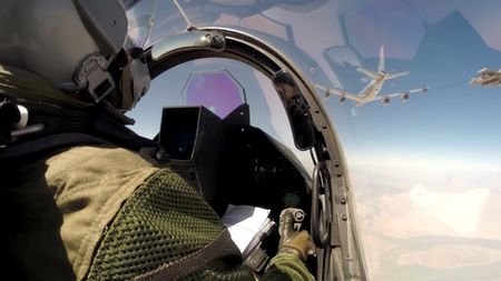 © Reuters. Handout shows a pilot of a French Rafale fighter jet during a mission from Al-Dhafra airbase