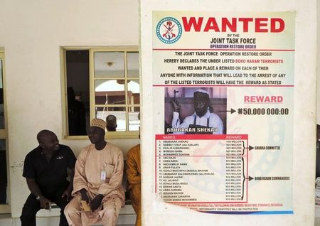 © Reuters. A poster advertising for the search of Boko Haram leader Abubakar Shekau is pasted on a wall in Baga