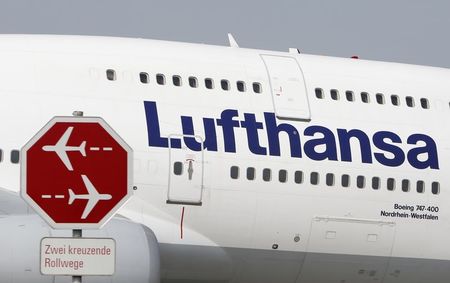 © Reuters. German airline Lufthansa aircraft taxis past a sign during a pilots' strike at Munich's airport