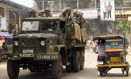 © Reuters. Soldiers ride in a truck as they patrol a road in Jolo, Sulu