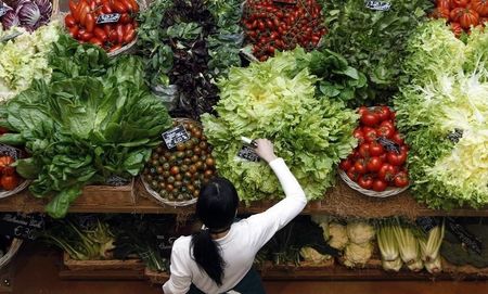 © Reuters. Employee arranges pricetags at vegetables work bench during the opening day of upmarket Italian food hall chain Eataly's flagship store in downtown Milan