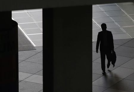 © Reuters. A man walks past a corridor at a commercial building in Tokyo's business district