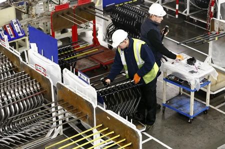 © Reuters. Workers inspect components on the fuel inlet production facility in Foston