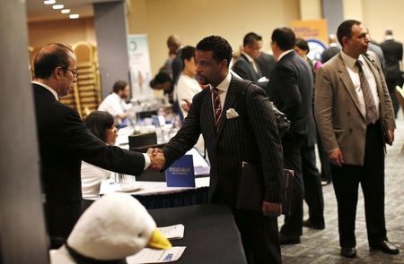 © Reuters. A job seeker meets with a prospective employer at a career fair in New York City