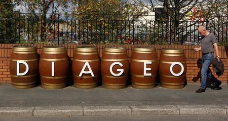 © Reuters. A man walks past barrels outside the Diageo Shieldhall facility near Glasgow, Scotland