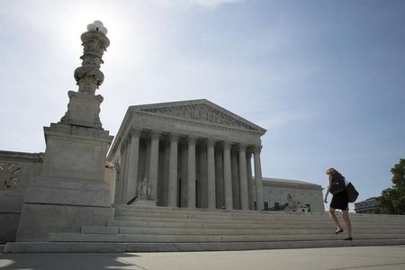 © Reuters. A woman walks to the Supreme Court in Washington