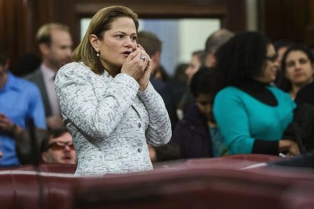 © Reuters. New York City councilwoman Melissa Mark-Viverito covers her mouth as she speaks on a phone prior to her election for speaker of the city council inside of City Hall in the Manhattan borough of New York