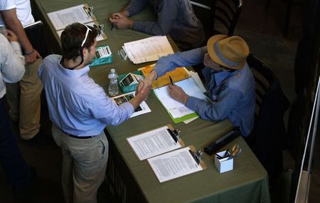 © Reuters. Job applicant shakes hands with a recruiter at the Terrapin Care Station company booth at the CannaSearch cannabis industry job fair in downtown Denver